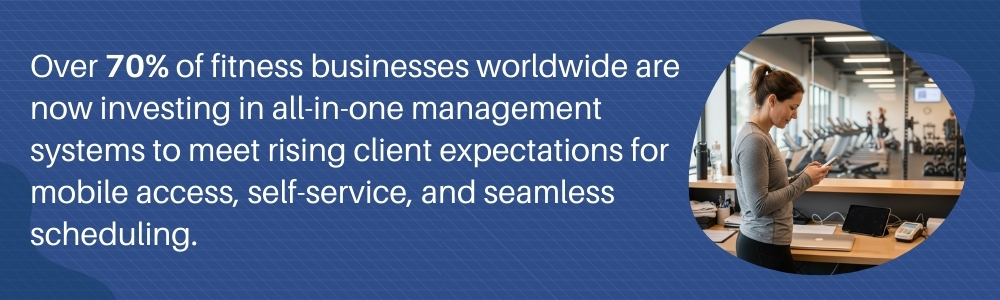 Gym staff checking booking notification on phone at fitness reception Gym staff checking booking notification on phone at fitness reception
